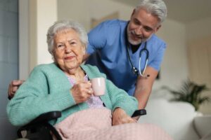 Older adults participating in a gentle group exercise class with supportive staff nearby.