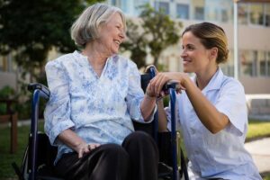 Senior using a handrail in a well-lit assisted living hallway with high-contrast signs and clear pathways